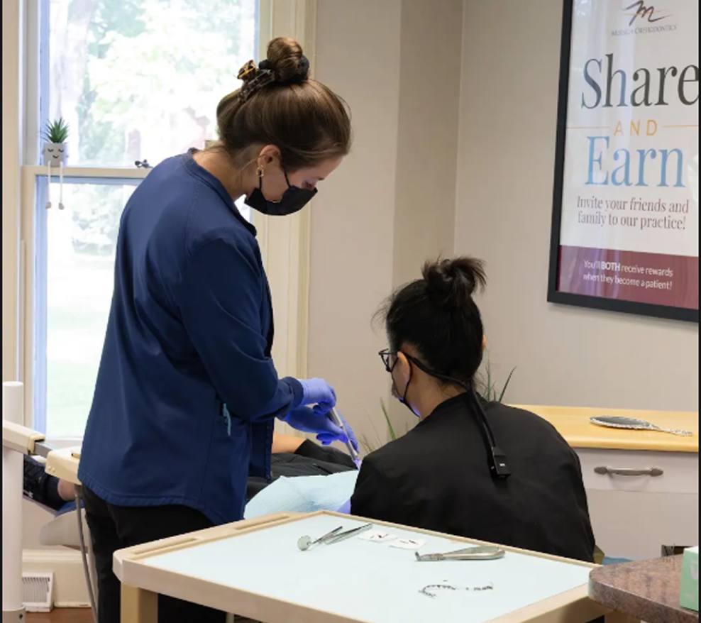 Dr. Lee and Kaitlyn with a patient at Muench Orthodontics
